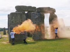 Screen grab taken from handout video of Just Stop Oil protesters spraying an orange substance on Stonehenge (Just Stop Oil/PA)