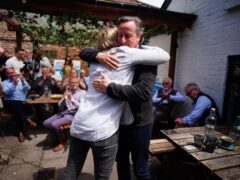Foreign Secretary Lord David Cameron greets parliamentary candidate for Wells and Mendip Hills, Meg Powell-Chandler, during a visit to the Lamb Inn in Axbridge, Somerset (Ben Birchall/PA)
