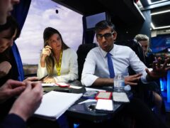 Prime Minister Rishi Sunak talks to journalists on board his campaign battle bus after visiting a bathroom supply company near Rhyl, Wales, while on the General Election campaign trail (Aaron Chown/PA)