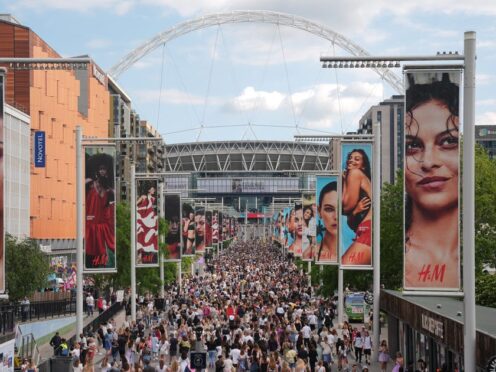 Fans gather outside Wembley Stadium ahead of Taylor Swift’s first London concert, during her Eras Tour (PA)