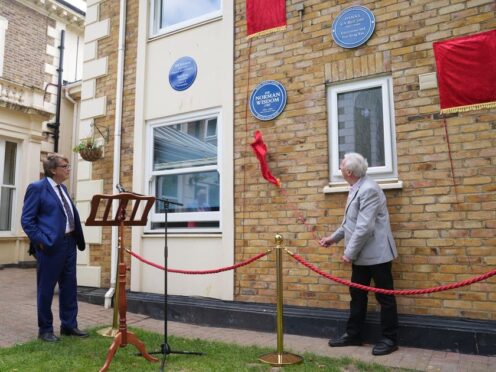 DJ Mike Read watches as Johnny Mans, who represented Sir Norman Wisdom, unveils a Blue Plaque in his name (Lucy North/PA)