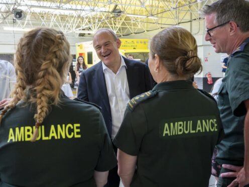 Liberal Democrat leader Sir Ed Davey meets paramedics on the campaign trail in Wimbledon (Jeff Moore/PA)