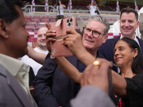 Labour Party leader Sir Keir Starmer (centre right) during a visit to Northampton Town Football Club (Jacob King/PA)
