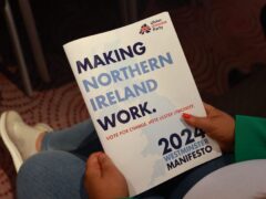 A party supporter holds the UUP manifesto at the Stormont Hotel in Belfast (Liam McBurney/PA)