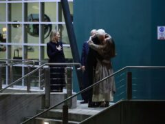 WikiLeaks founder Julian Assange embraces his wife Stella as he arrives in Canberra (Hilary Wardhaugh/PA)