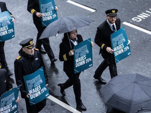 Aer Lingus pilots march around Dublin Airport as they begin their eight-hour strike (Evan Treacy/PA)