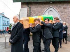 The coffin is brought from St Mary’s Church in Dingle, Co Kerry following the funeral of renowned Gaelic Games commentator Micheal O Muircheartaigh at St Mary’s Church in Dingle, Co Kerry (Noel Sweeney/PA)