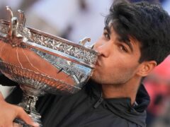Spain’s Carlos Alcaraz kisses the trophy after winning the men’s final at the French Open (Christophe Ena/AP)