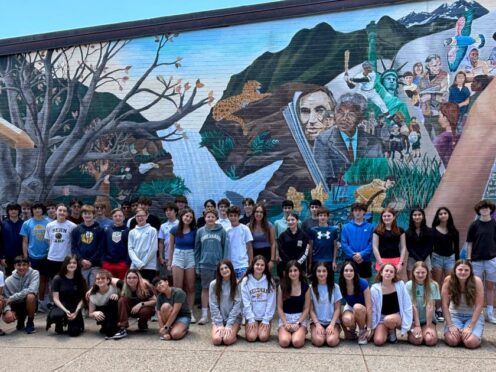 This image provided by Tamatha Bibbo, principal of the Pollard Middle School in Needham, Massachusetts, shows 23 sets of twins who graduated from Pollard Middle School (Tamatha Bibbo via AP)