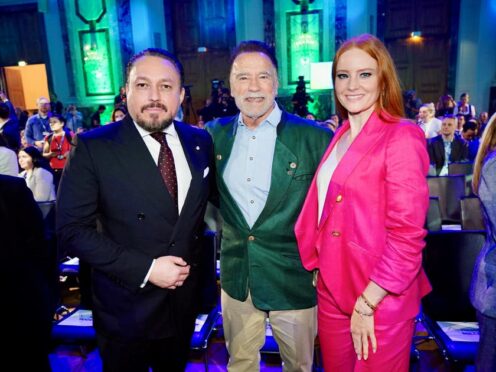 Arnold Schwarzenegger, centre, with film producer Klemens Hallmann and model Barbara Meier (PA/Andreas Tischler)