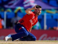 England’s Mark Wood celebrates after taking the wicket of Oman’s Ayaan Khan (Ricardo Mazalan/AP)