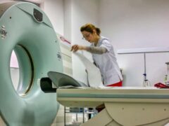 A nurse arranging the MRI machine (Alamy/PA)