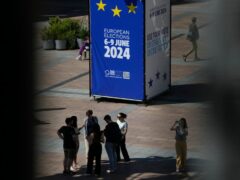 People stand on the outside esplanade during a voting event at the European Parliament in Brussels (Virginia Mayo/AP)