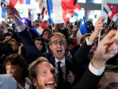 Supporters of French far-right National Rally react at the party election night headquarters in Paris (Lewis Joly/AP)