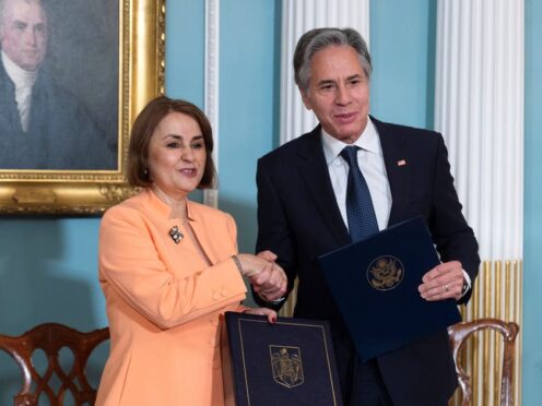 Secretary of State Antony Blinken and Romanian foreign minister Luminița-Teodora Odobescu shake hands after signing a memorandum of understanding during a ceremony in the Treaty Room at the State Department, in Washington, on Friday (Manuel Balce Ceneta/AP)