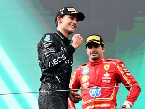 Mercedes driver George Russell of Britain, left, celebrates on the podium after winning the Austrian Formula One Grand Prix race at the Red Bull Ring racetrack in Spielberg, Austria, Sunday, June 30, 2024. (AP Photo/Christian Bruna)