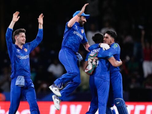 Afghanistan players celebrate after defeating Australia by 21 runs (Ramon Espinosa/AP)