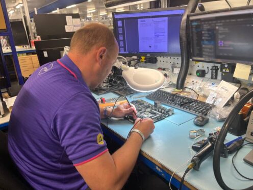 A technician working at Currys’ Repair Centre in Newark, Nottinghamshire (Rebecca Speare-Cole/PA)