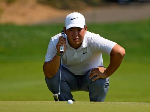 Tom Kim lines up a putt on the 15th hole (Seth Wenig/AP)