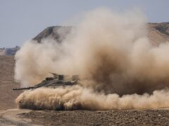 Israeli soldiers drive a tank near the Israeli-Gaza border, in southern Israel (Tsafrir Abayov/AP)