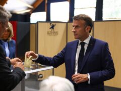 French President Emmanuel Macron votes during the European election (Hannah McKay/PA)