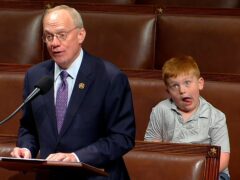 John Rose speaking on the floor of the House of Representatives as his son Guy makes faces (House Television via AP)