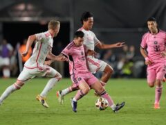 Inter Miami forward Lionel Messi, centre front, works to retain control of the ball under pressure from St Louis City defender Tomas Totland, left, and midfielder Hosei Kijima (Rebecca Blackwell/AP)