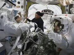 Nasa astronauts inside the Quest airlock (Nasa TV via AP)