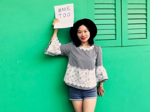 Chinese journalist Huang Xueqin holds up a #MeToo sign in Singapore in 2017 (Free Huang Xueqin && Wang Jianbing via AP)