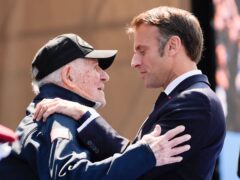 Emmanuel Macron greets a Second World War veteran (Evan Vucci/AP)