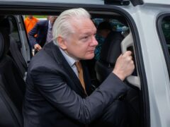 WikiLeaks founder Julian Assange leaves the federal court in Saipan, Mariana Islands (Eugene Hoshiko/AP)