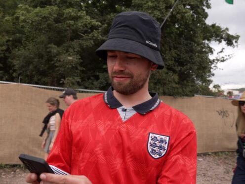 England football fan Alistair Tomlinson has been trying to follow the Euro 2024 knockout match against Slovakia at Glastonbury festival (Tom Leese/PA)