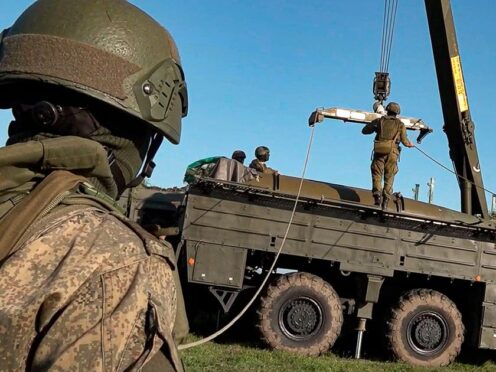 Russian troops prepare a missile launcher for joint Russian-Belarusian drills intended to train the military to use tactical nuclear weapons (Russian Defence Ministry/AP)