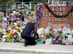 FILE – Reggie Daniels pays his respects at a memorial at Robb Elementary School, June 9, 2022, in Uvalde, Texas (Eric Gay/AP, File)