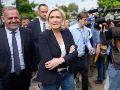 French far right leader Marine Le Pen, centre, with local mayor Steeve Briois, after voting in the first round of the parliamentary election (AP Photo/Thibault Camus)