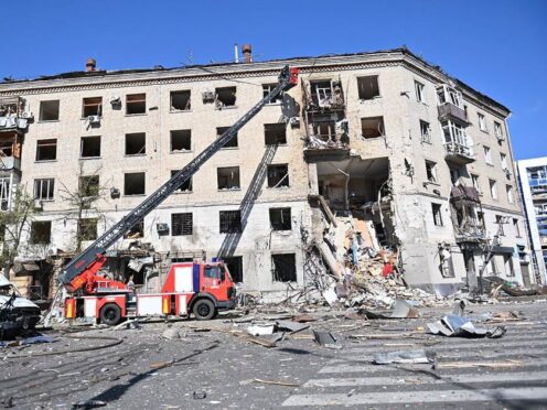 Rescuers work at the scene of a bombing which hit an apartment building in Kharkiv (Ukrainian Emergency Service/AP)