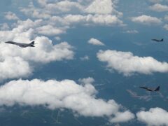 A US Air Force B-1B bomber, left, and South Korean F-15K fighters fly over the Korean Peninsula (South Korea Defence Ministry via AP)