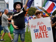 Protesters hold placards during a rally against antisemitism in Sydney (Bianca De Marchi/AAP Image via AP)