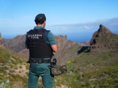 A Spanish police officer looks over the village of Masca, Tenerife, during the search for missing British teenager Jay Slater (James Manning/PA)