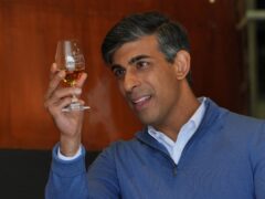 Prime Minister Rishi Sunak looks at a single malt whisky during a visit to the Cotswolds Distillery in Shipston-on-Stour, Warwickshire (Jonathan Brady/PA)