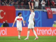 Merih Demiral, right, gestures to the crowd after scoring Turkey’s second goal against Austria (Adam Davy/PA)
