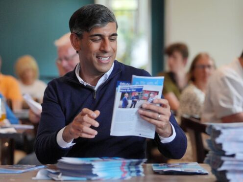 Rishi Sunak sorts Conservative election leaflets on the final day of the campaign (Jonathan Brady/PA)