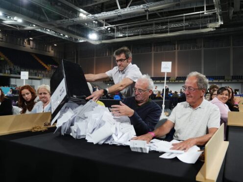 Ballot boxes are emptied at Emirates Arena in Glasgow (Andrew Milligan/PA)