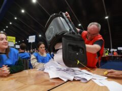 A ballot box is emptied at the Titanic Exhibition Centre, Belfast (PA)