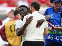 England manager Gareth Southgate and Bukayo Saka celebrate after victory over Switzerland (Adam Davy/PA)