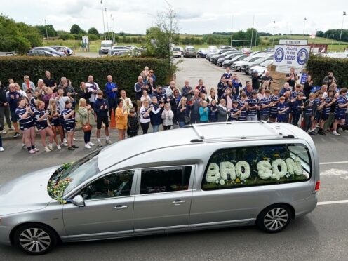 The funeral cortege passes through Featherstone town centre (Peter Byrne/PA)