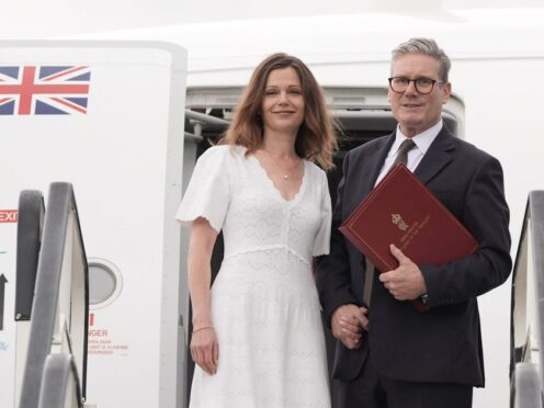 Prime Minister Sir Keir Starmer and his wife Victoria board a plane (Stefan Rousseau/PA)