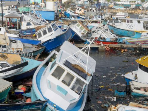 Fishing vessels damaged by Hurricane Beryl sit upended at the Bridgetown Fisheries in Barbados (Ricardo Mazalan/AP)