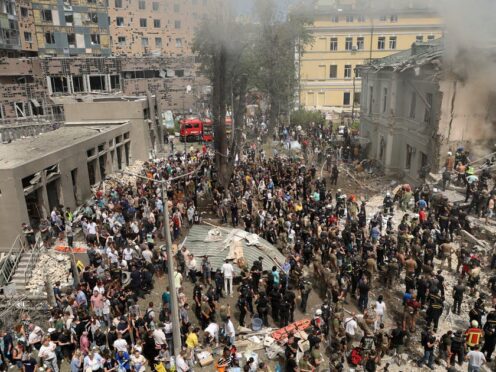 Rescuers and volunteers clean up the rubble and search for victims after a Russian missile hit the country’s main children hospital (Anton Shtuka/AP)