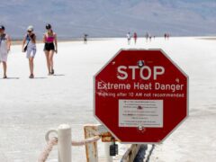 A stop sign warns tourists of extreme heat at Badwater Basin (Daniel Jacobi II/Las Vegas Review-Journal via AP)